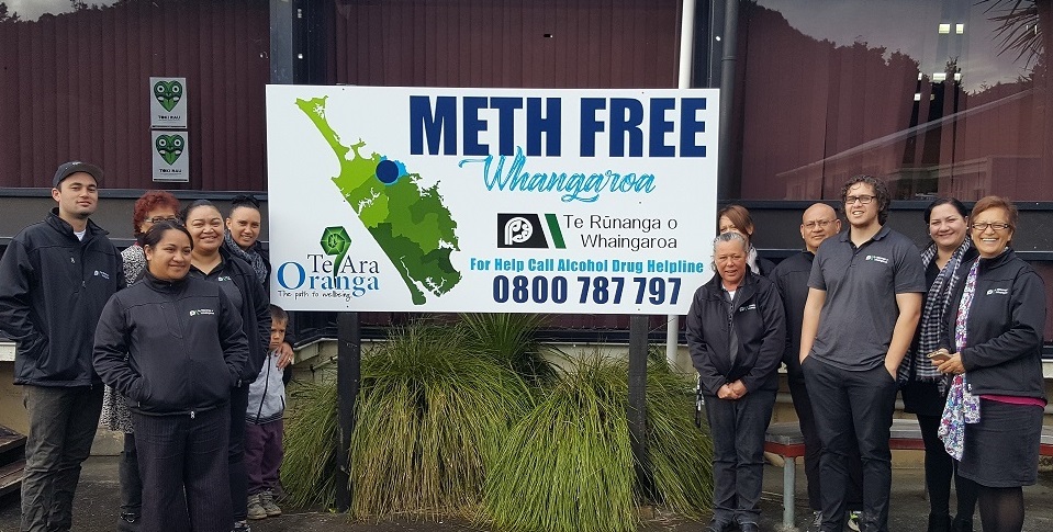 Staff from The Salvation Army Bridge standing in front of the Meth Free Whangaroa sign